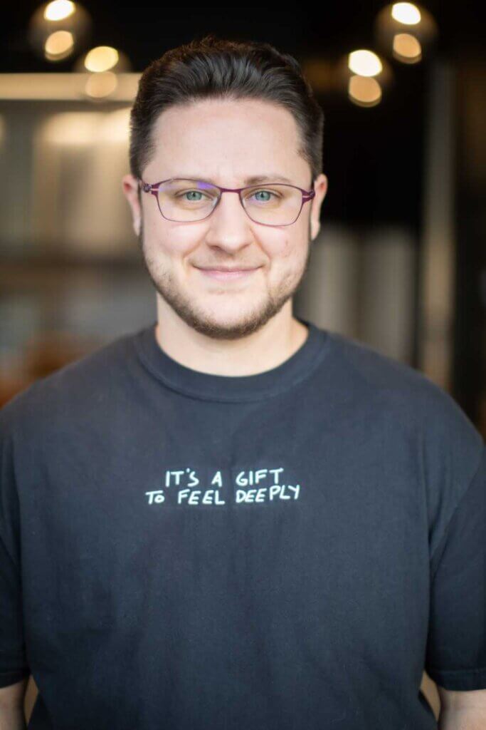 Photo of Dr. Ken wearing a t-shirt that reads "It's a gift to feel deeply"